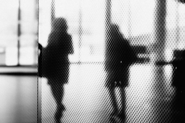 Artistic black and white still from an institutional video featuring professional subjects.