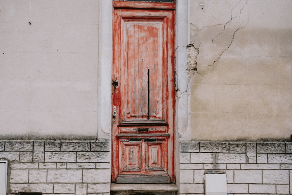 a red door on the side of a building