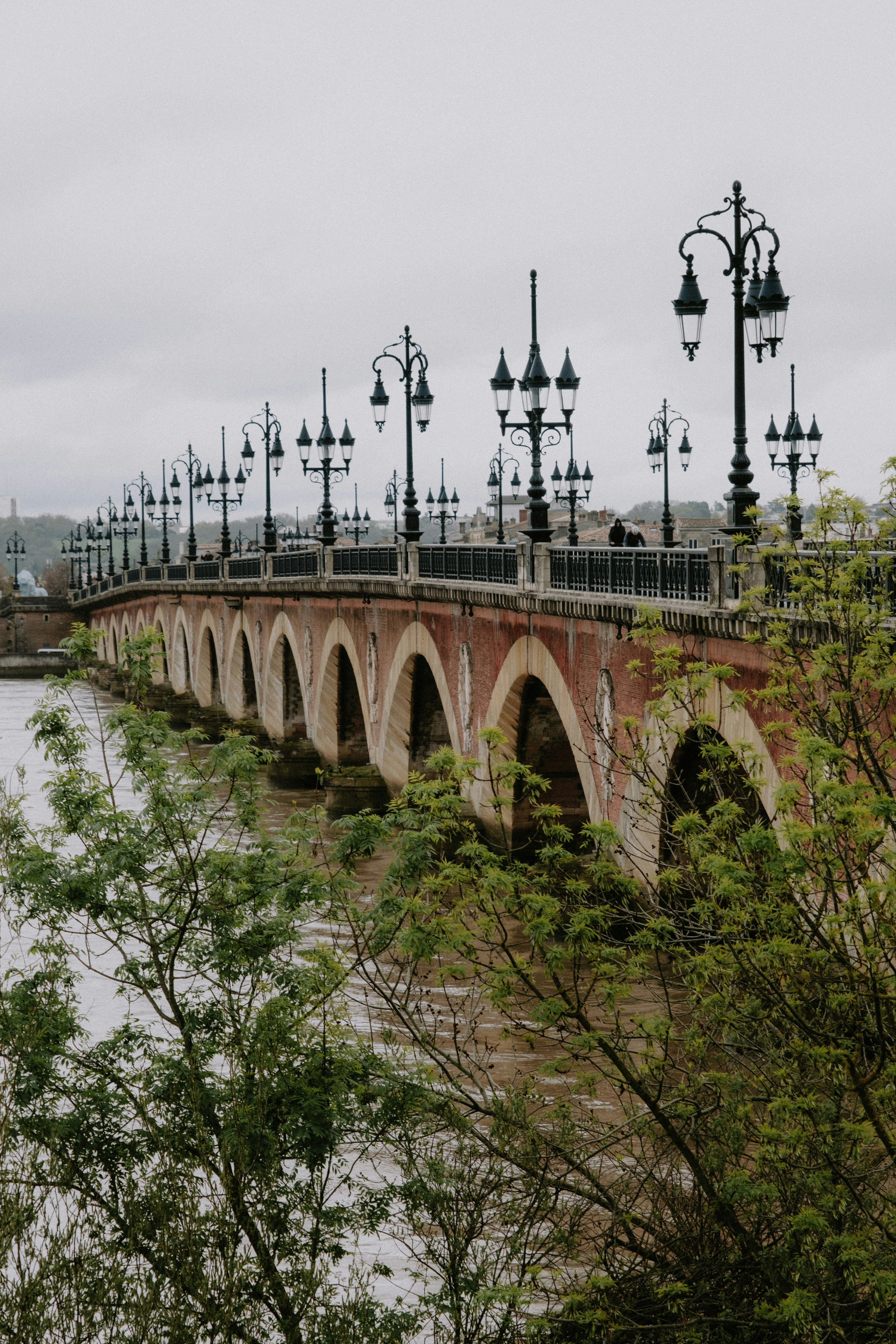 A bridge over a body of water surrounded by trees photo – Free Bordeaux ...