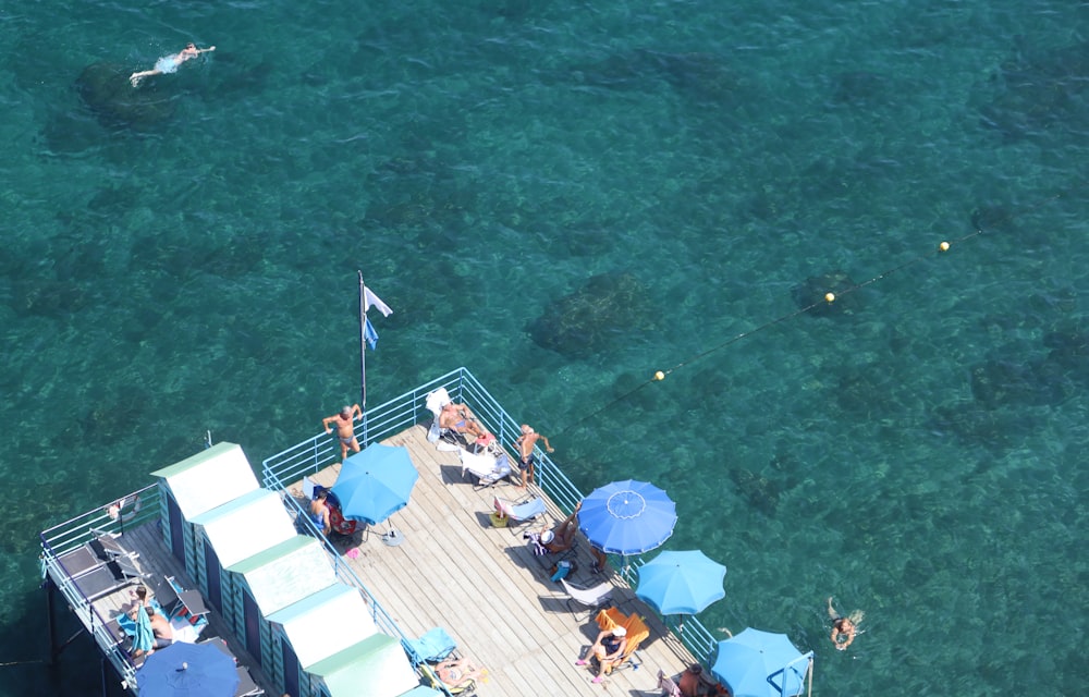 a group of people sitting on a boat in the water