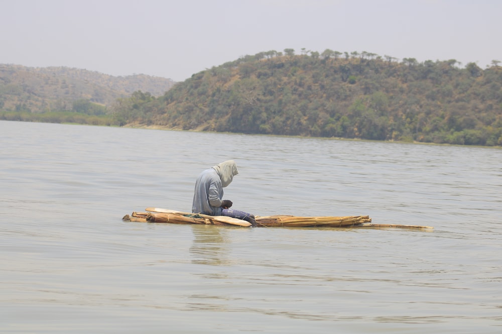 a man is sitting on a raft in the water