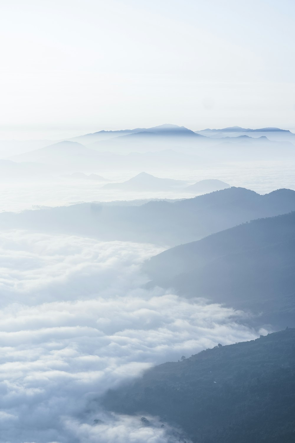 a view of a mountain range covered in clouds