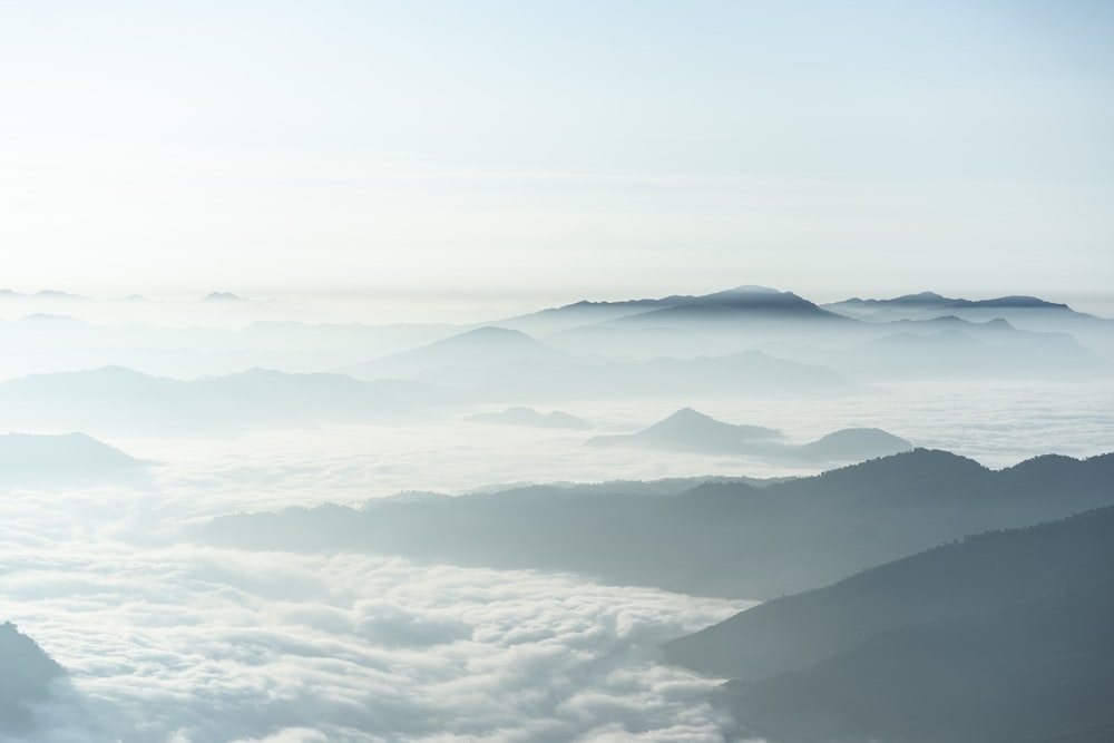 a view of a mountain range covered in clouds