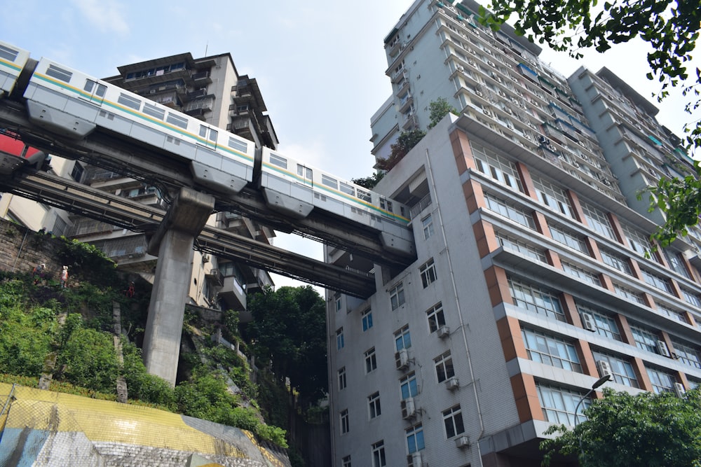 a train going over a bridge in a city