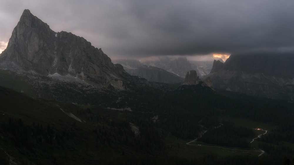 a mountain range under a cloudy sky