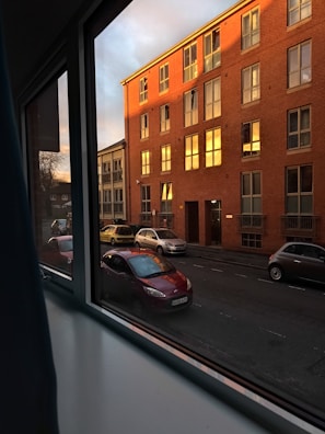 A scenic view from a window showing a quiet street.