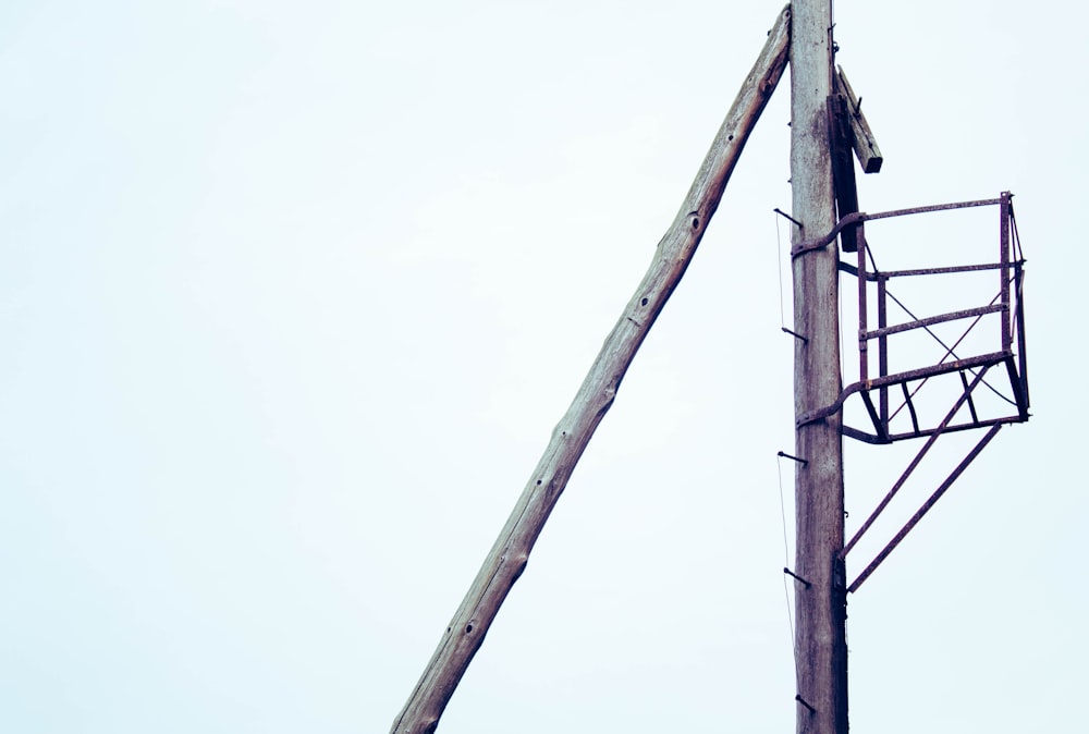 a crane is attached to a wooden pole