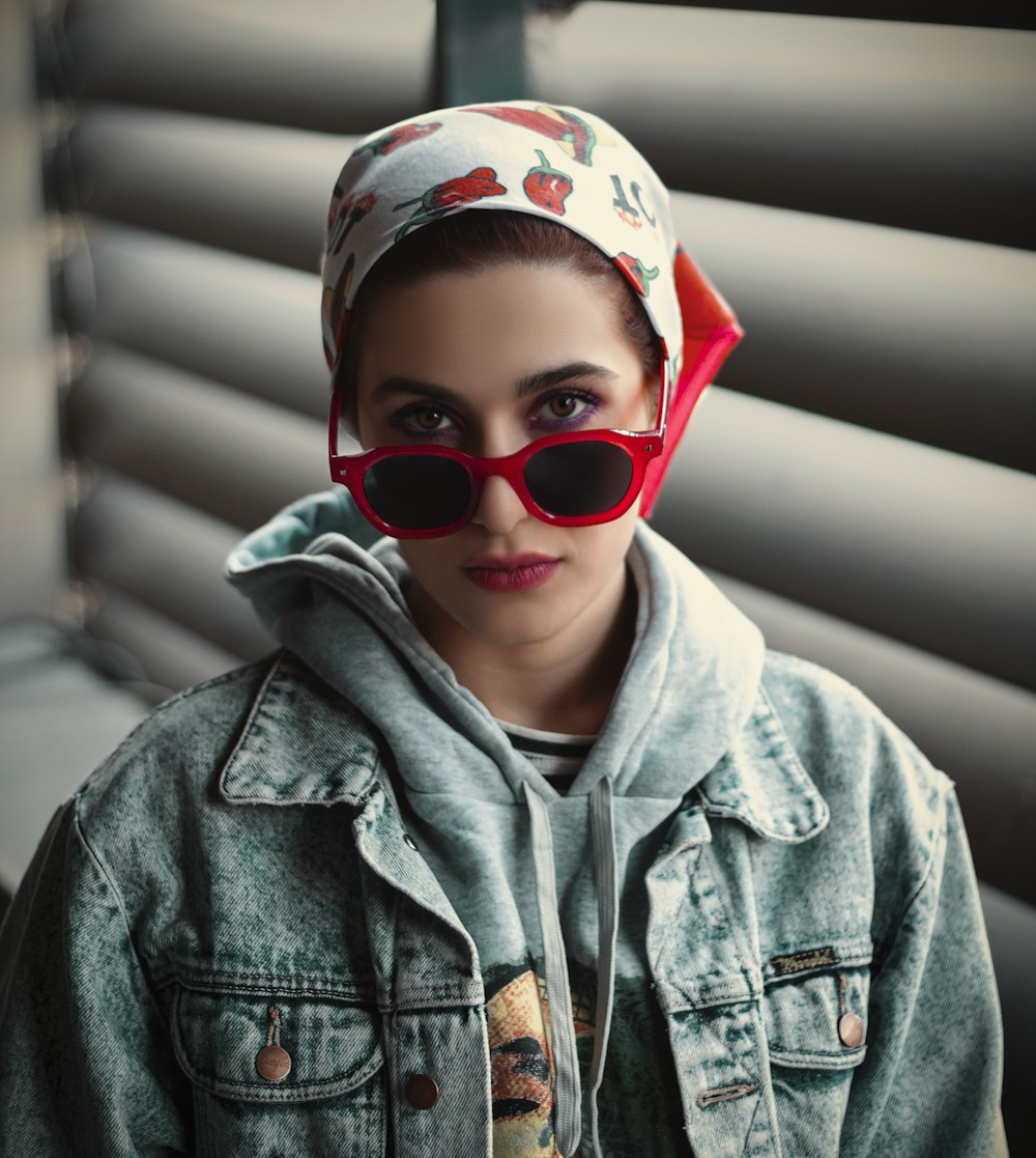 a woman wearing red sunglasses and a bandana