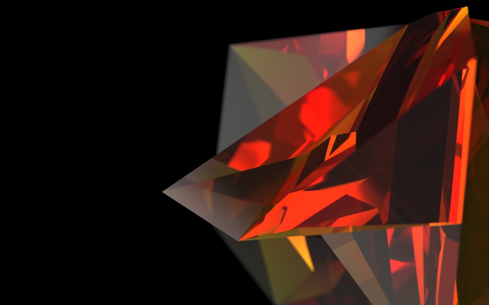 a close up of a red diamond on a black background
