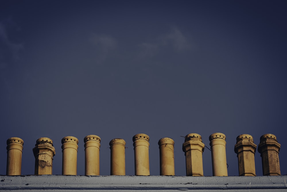 a row of stone pillars against a blue sky