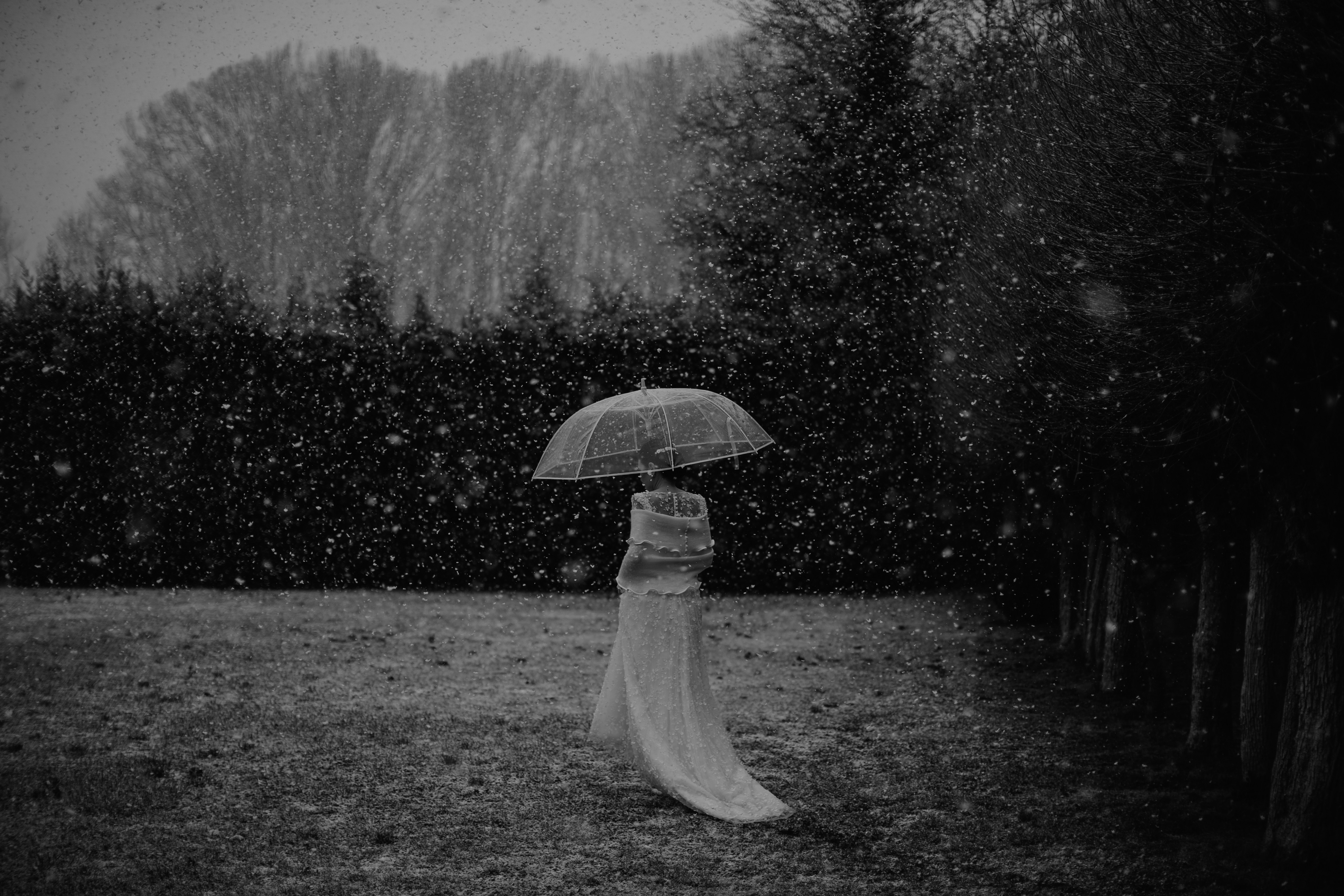 a woman in a white dress holding an umbrella