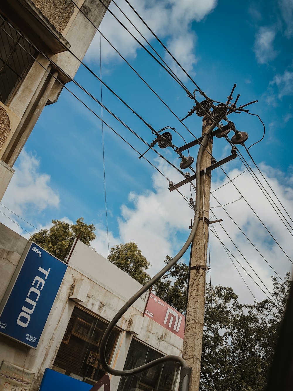 a telephone pole with many wires above it