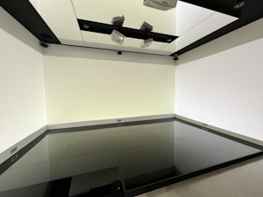 A modern living room showcasing glossy ceramic tiles with natural light reflecting off the floor.