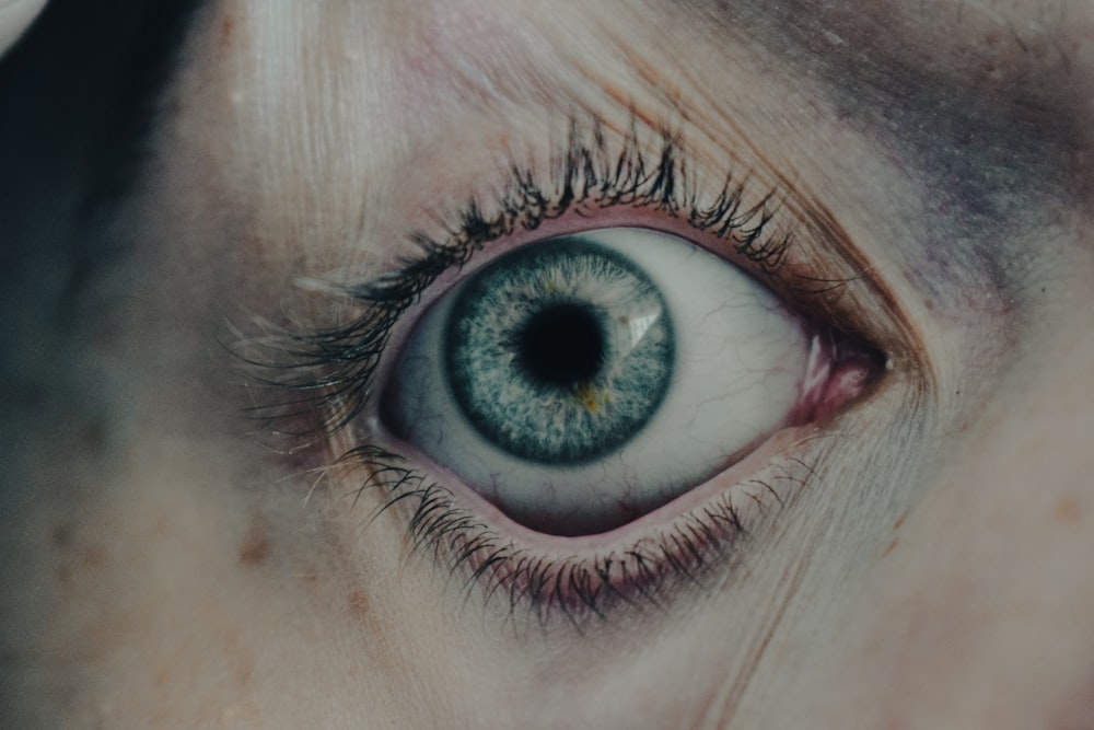 a close up of a person's blue eye