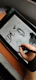 a person is drawing on a tablet with a pen
