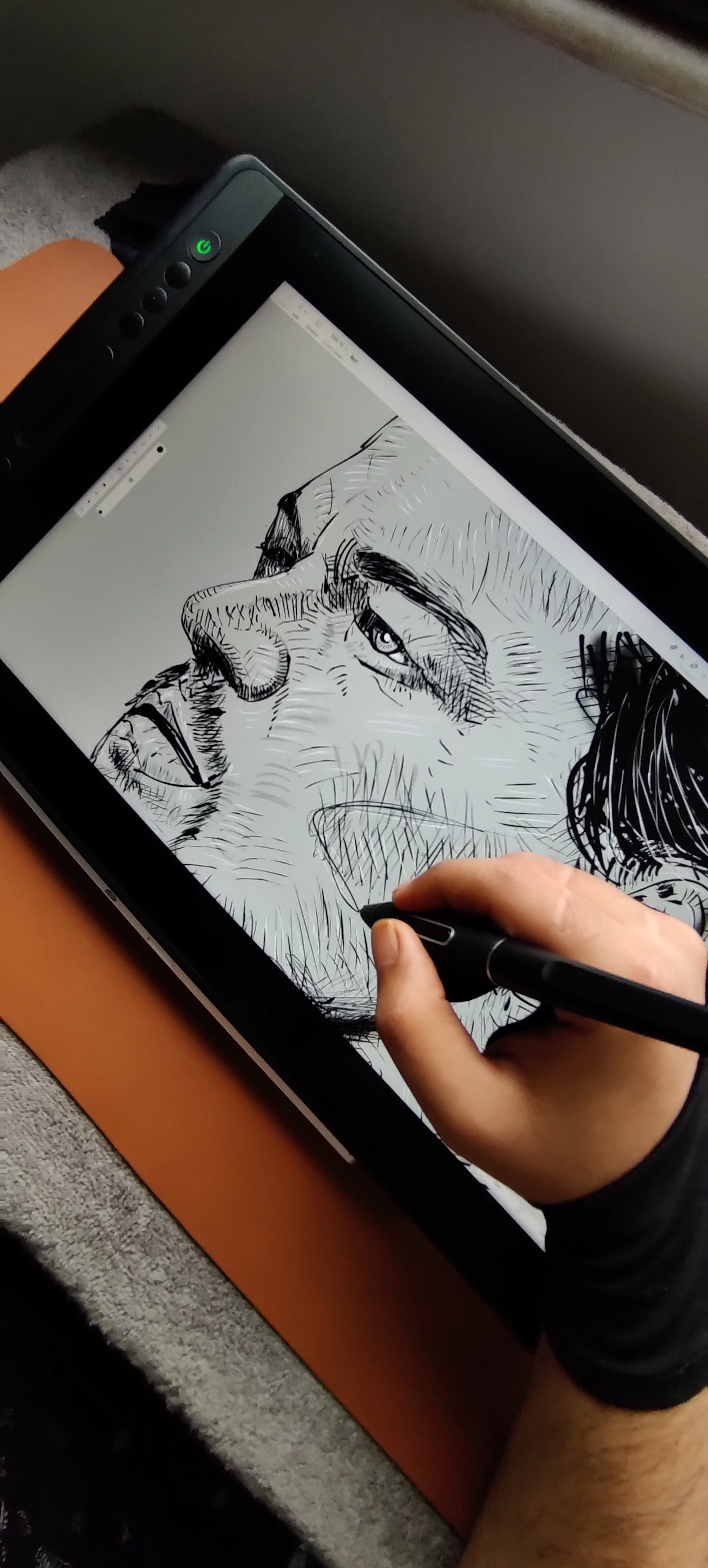 A designer drawing on a tablet