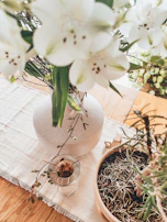 Close-up of a fresh floral arrangement on a minimalist wooden table by a sunny window.