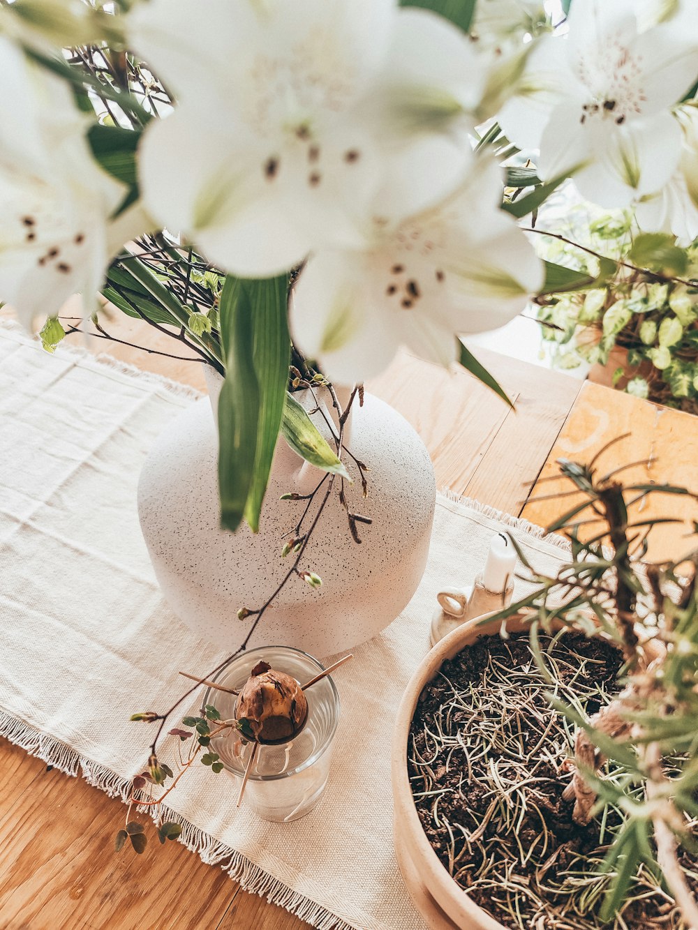 a vase filled with white flowers on top of a wooden table