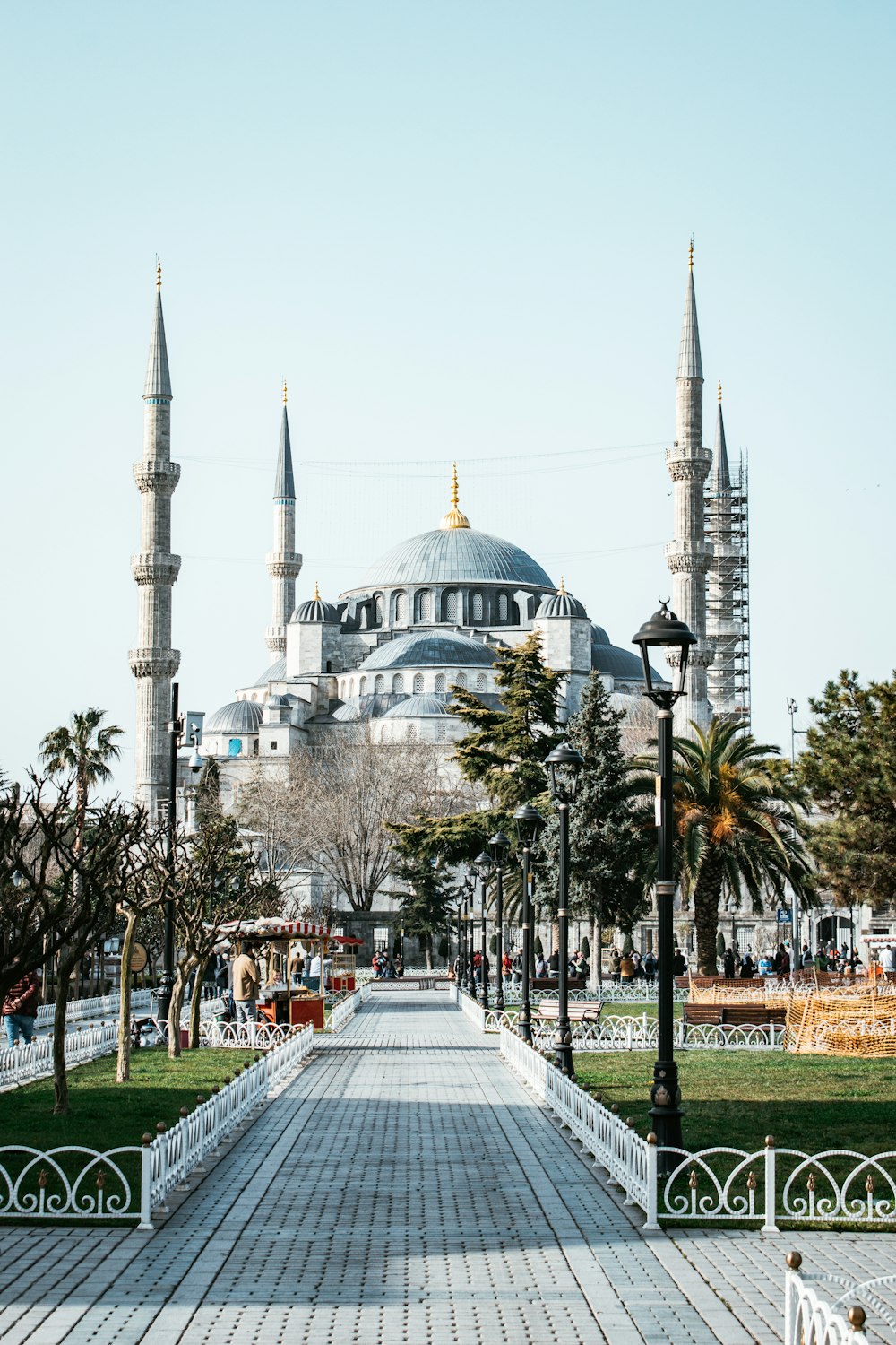 a walkway leading to a large building with many spires