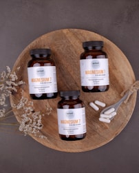 A serene setting with supplements and natural remedies arranged neatly on a wooden table.