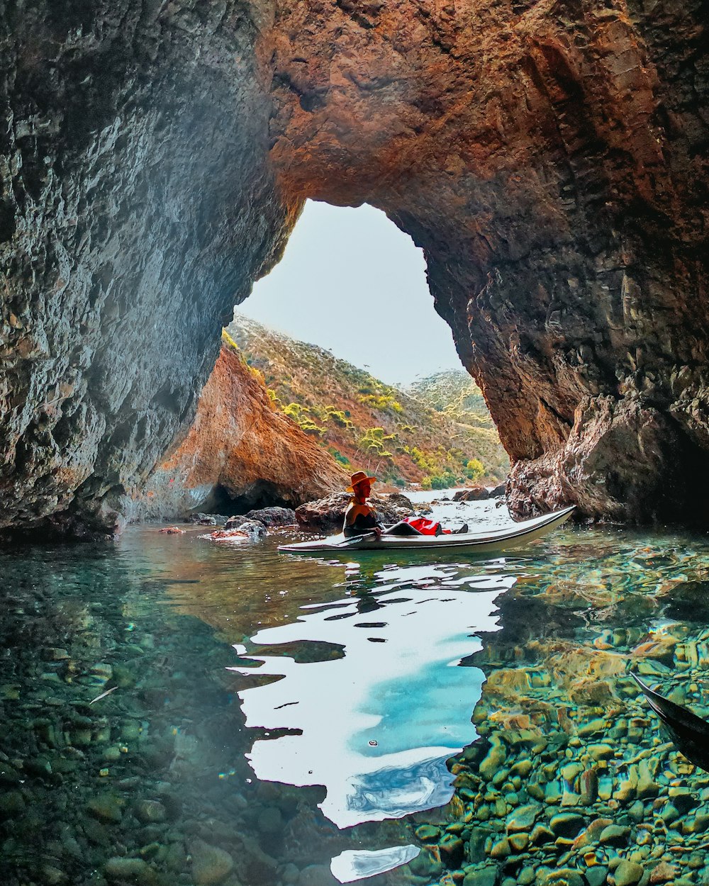 a person in a kayak inside of a cave
