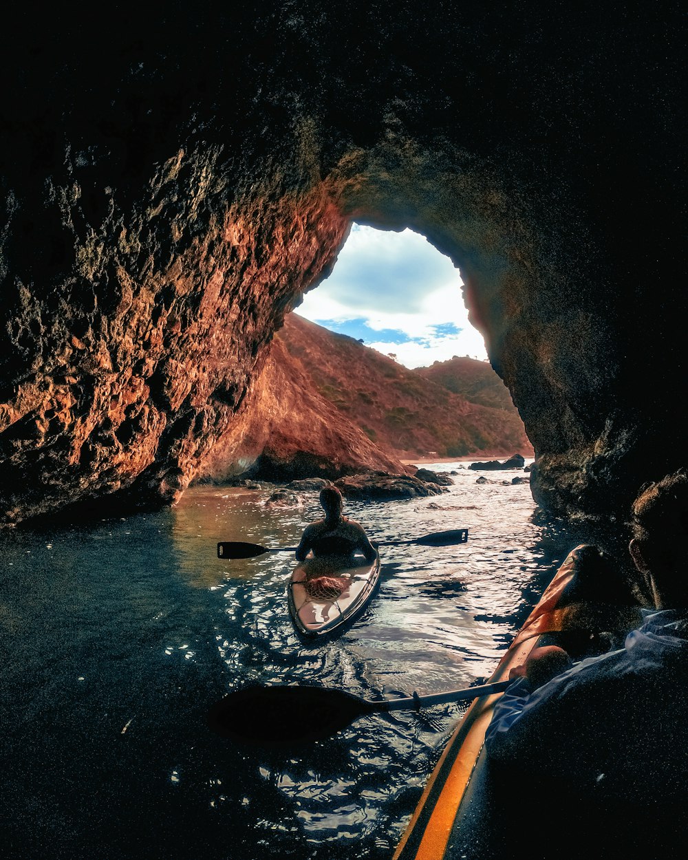 a person in a kayak in a cave