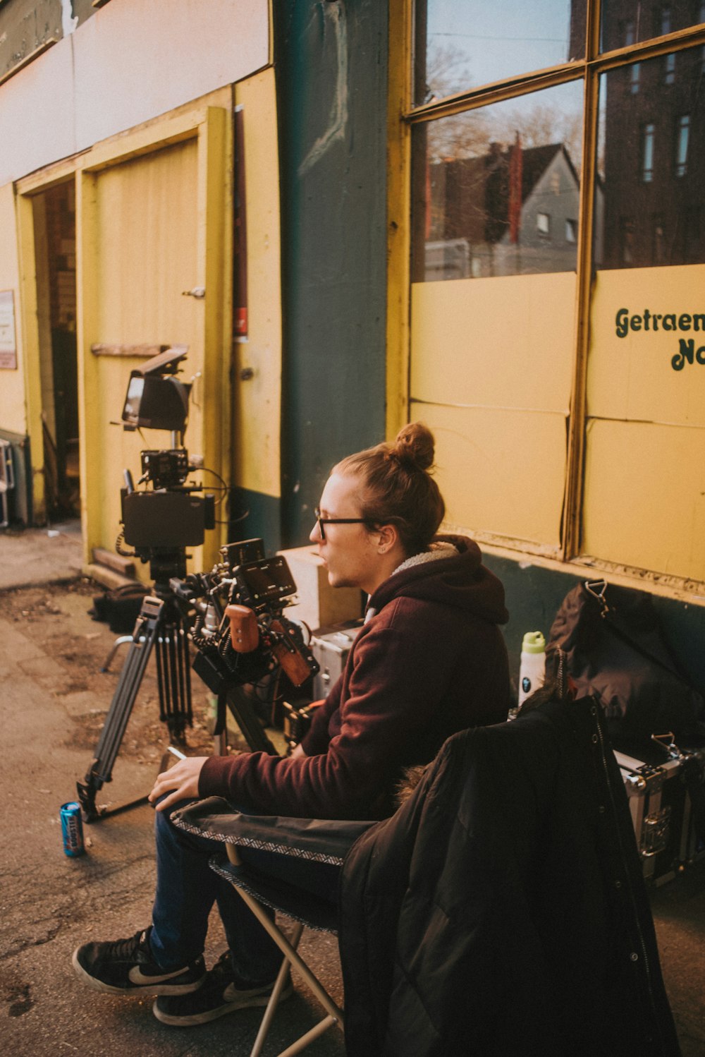 a woman sitting in a chair in front of a camera