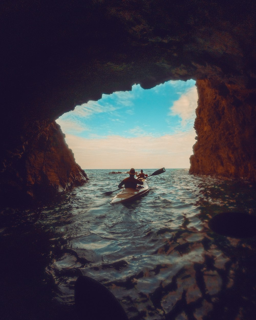 a person in a kayak in a cave