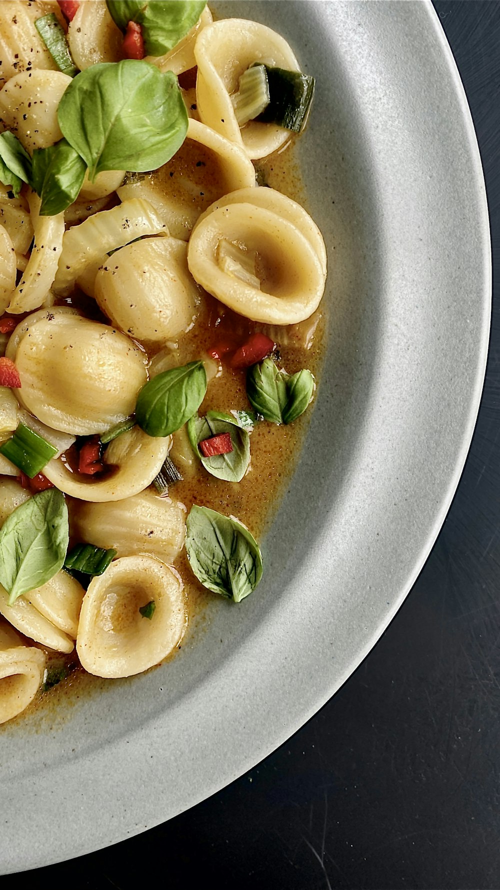 a white bowl filled with pasta and sauce