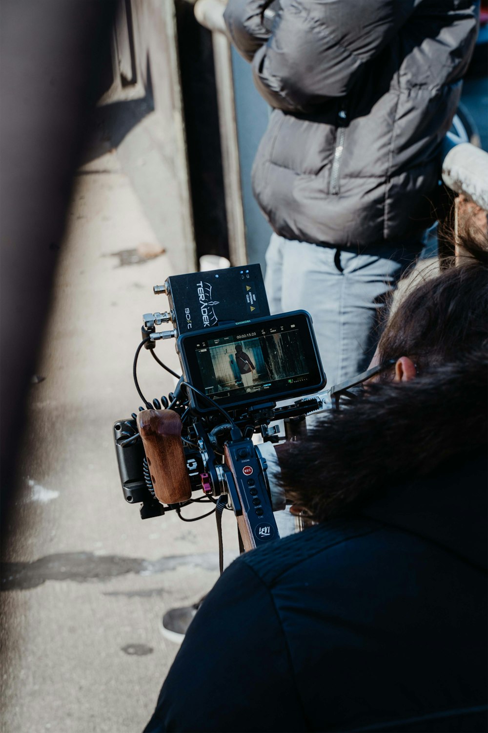 a man standing next to a person holding a camera