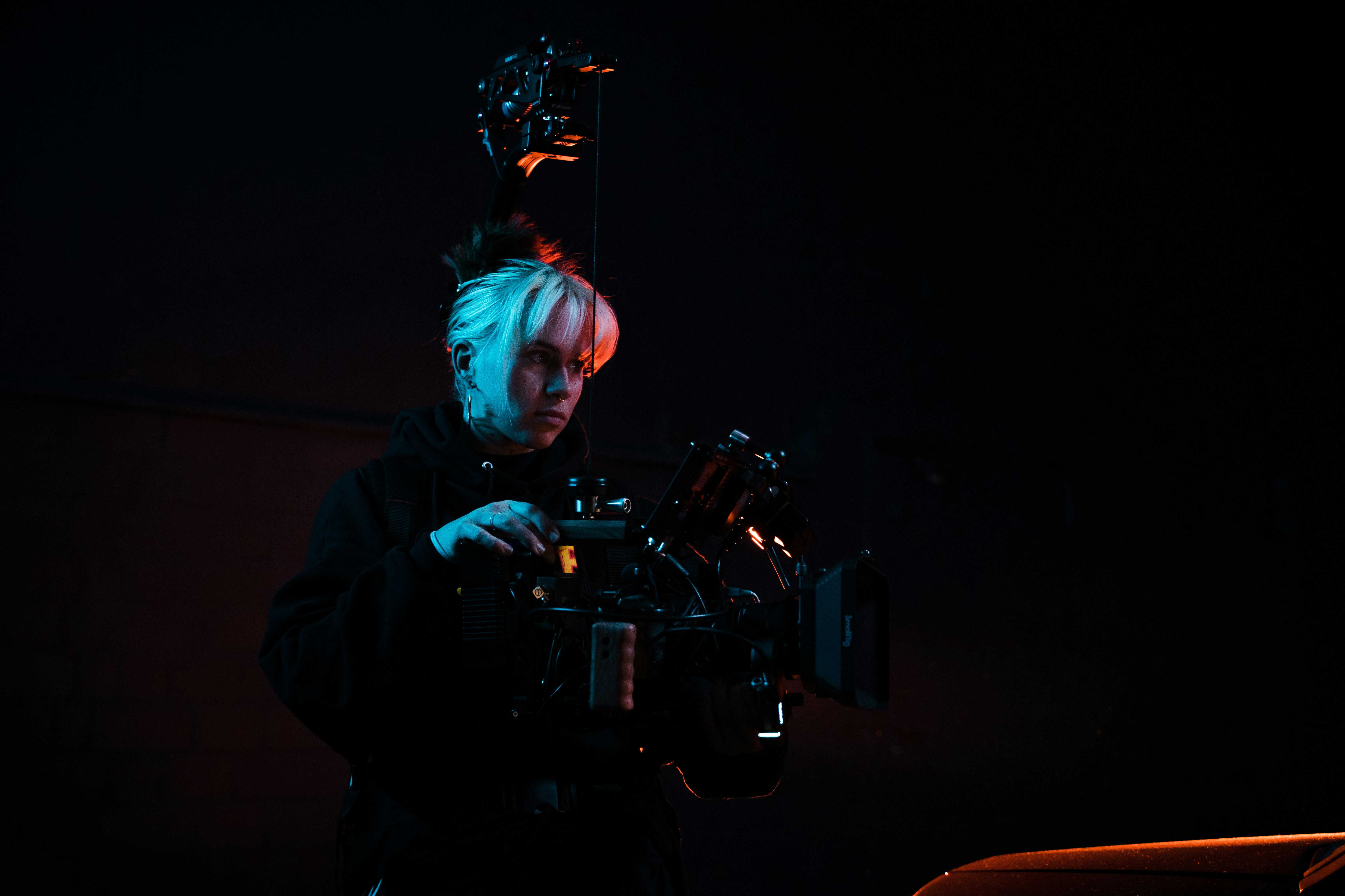a man holding a camera in the dark