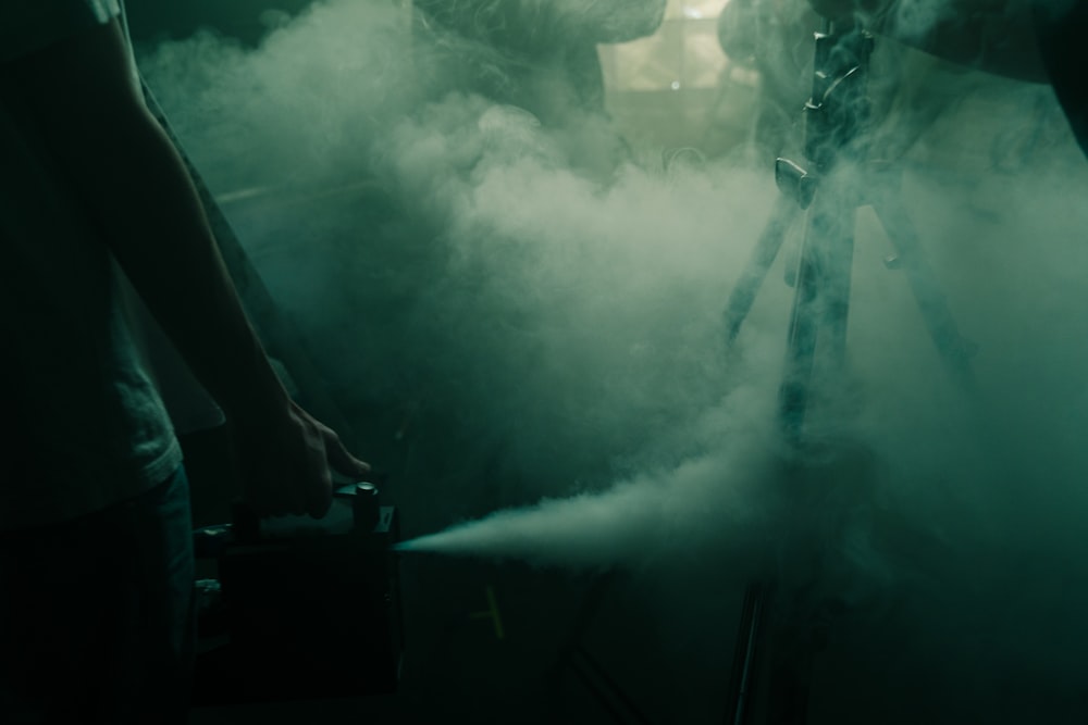 a man standing in front of a smoke machine