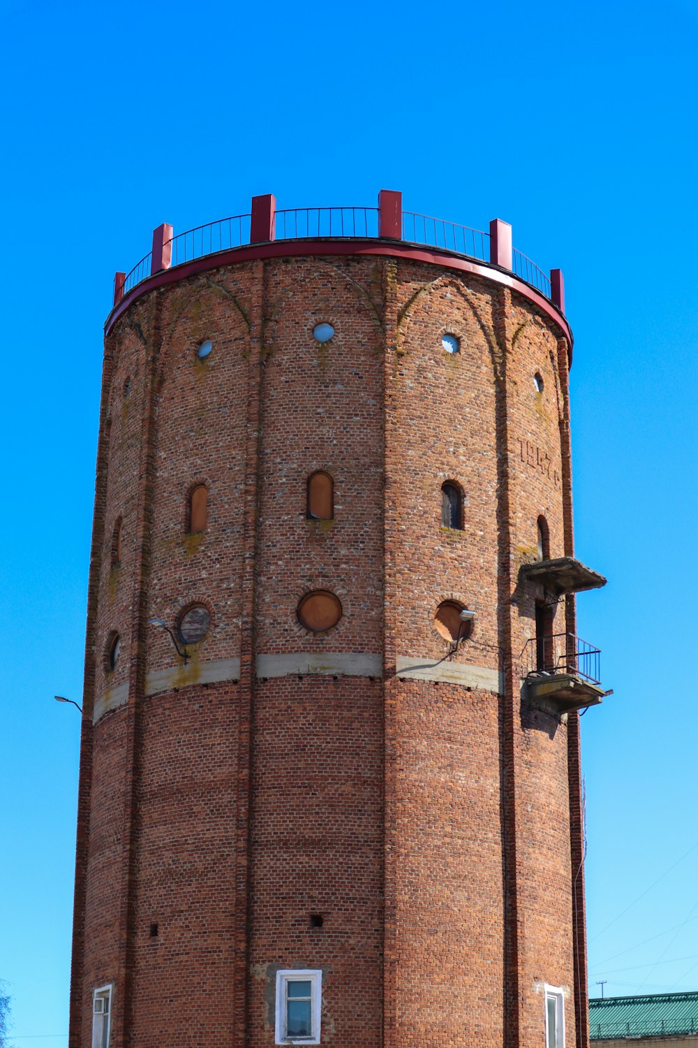 a tall brick tower with a clock on the top of it