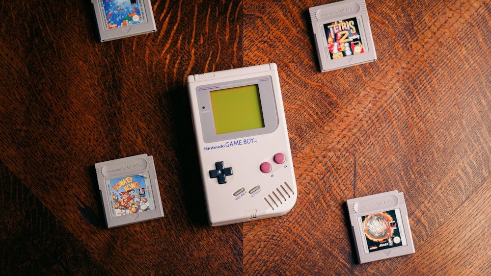 a nintendo game boy sitting on top of a wooden table
