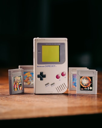 a nintendo game boy sitting on top of a wooden table