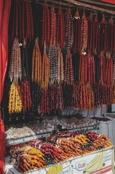 a bunch of sausage hanging from a red awning