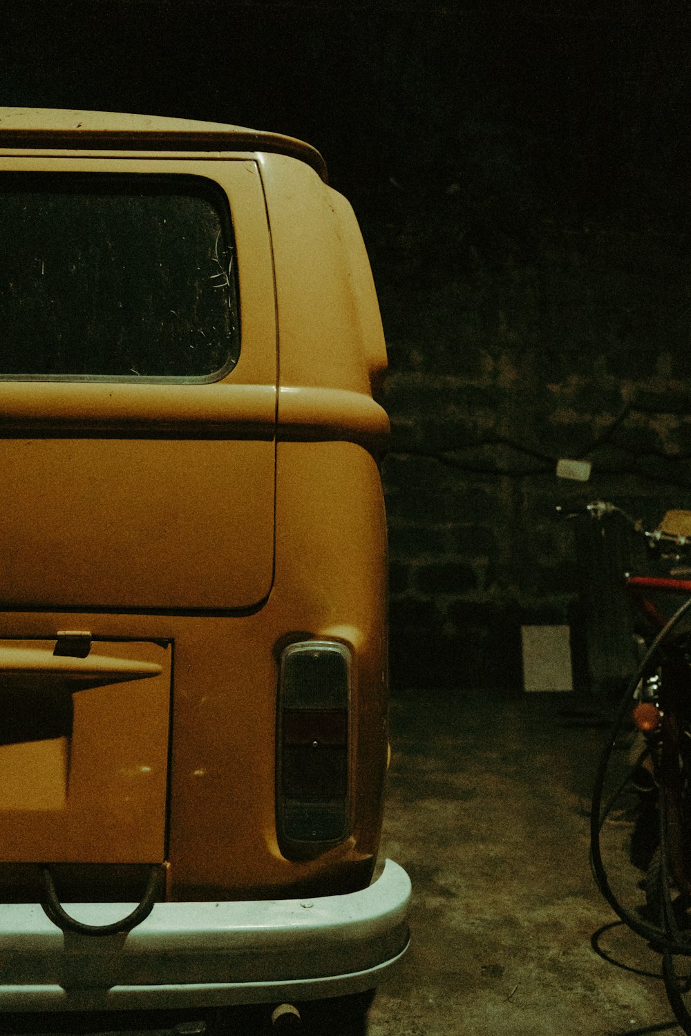 a yellow truck parked in a garage next to a bike