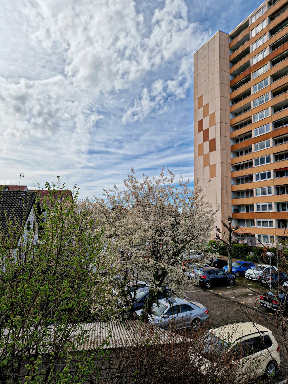 a parking lot in front of a tall building