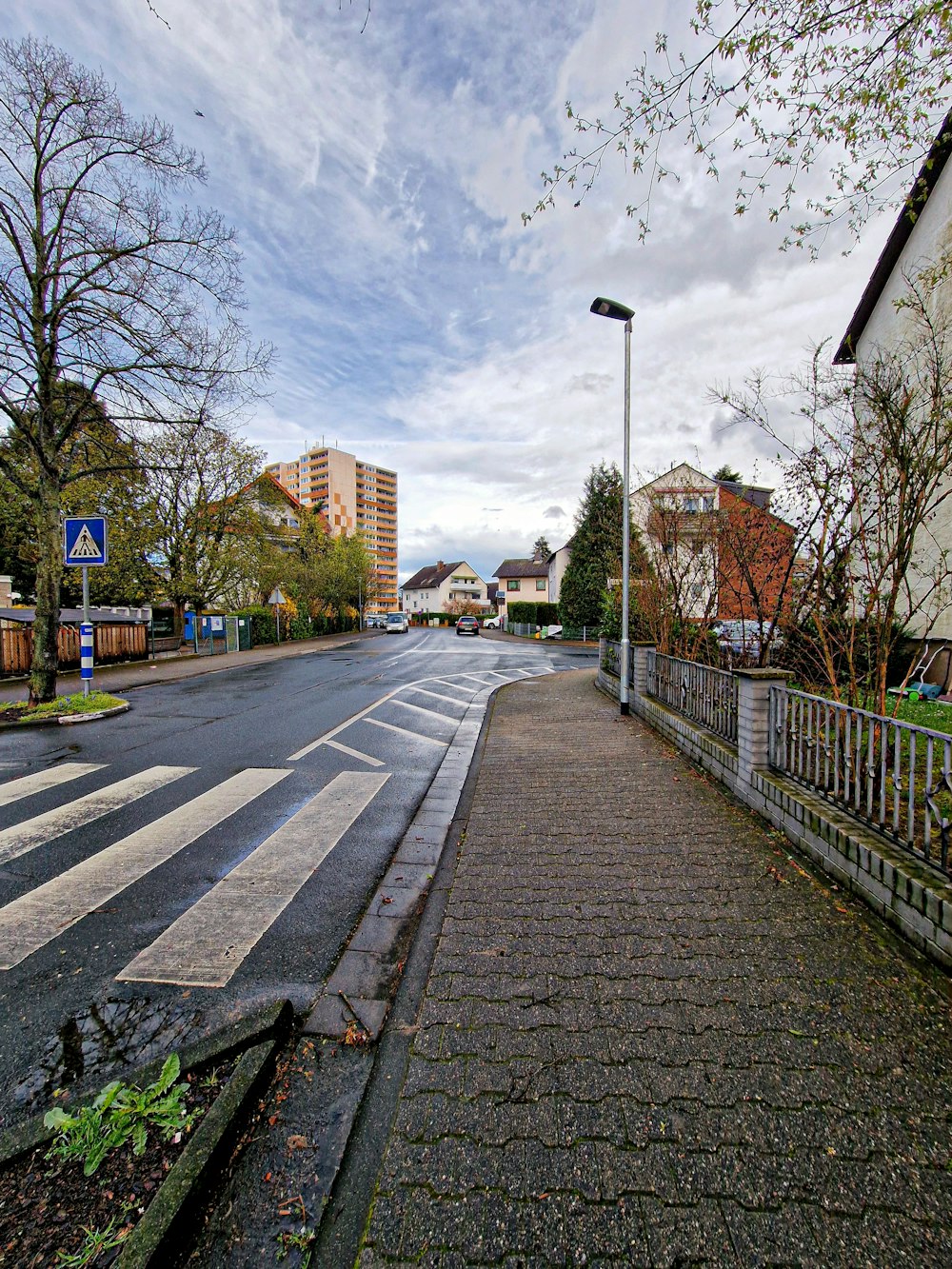 an empty street with a street light on the side of it