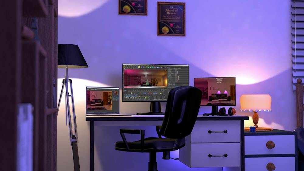 a computer desk with two monitors and a lamp