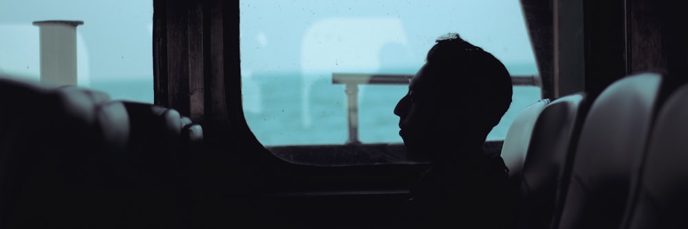 a person sitting on a bus looking out the window