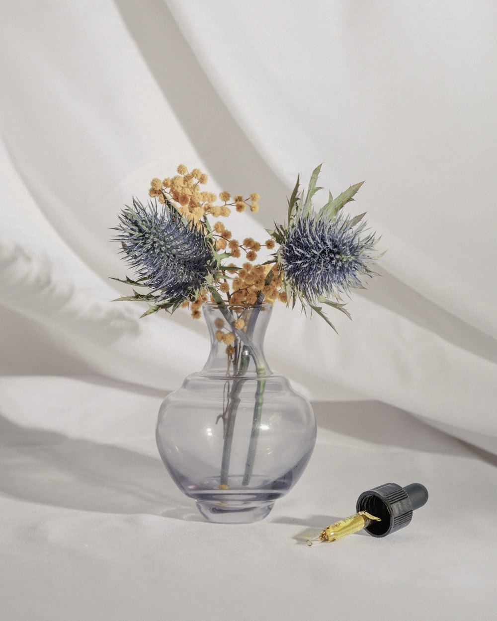 a glass vase with some flowers in it