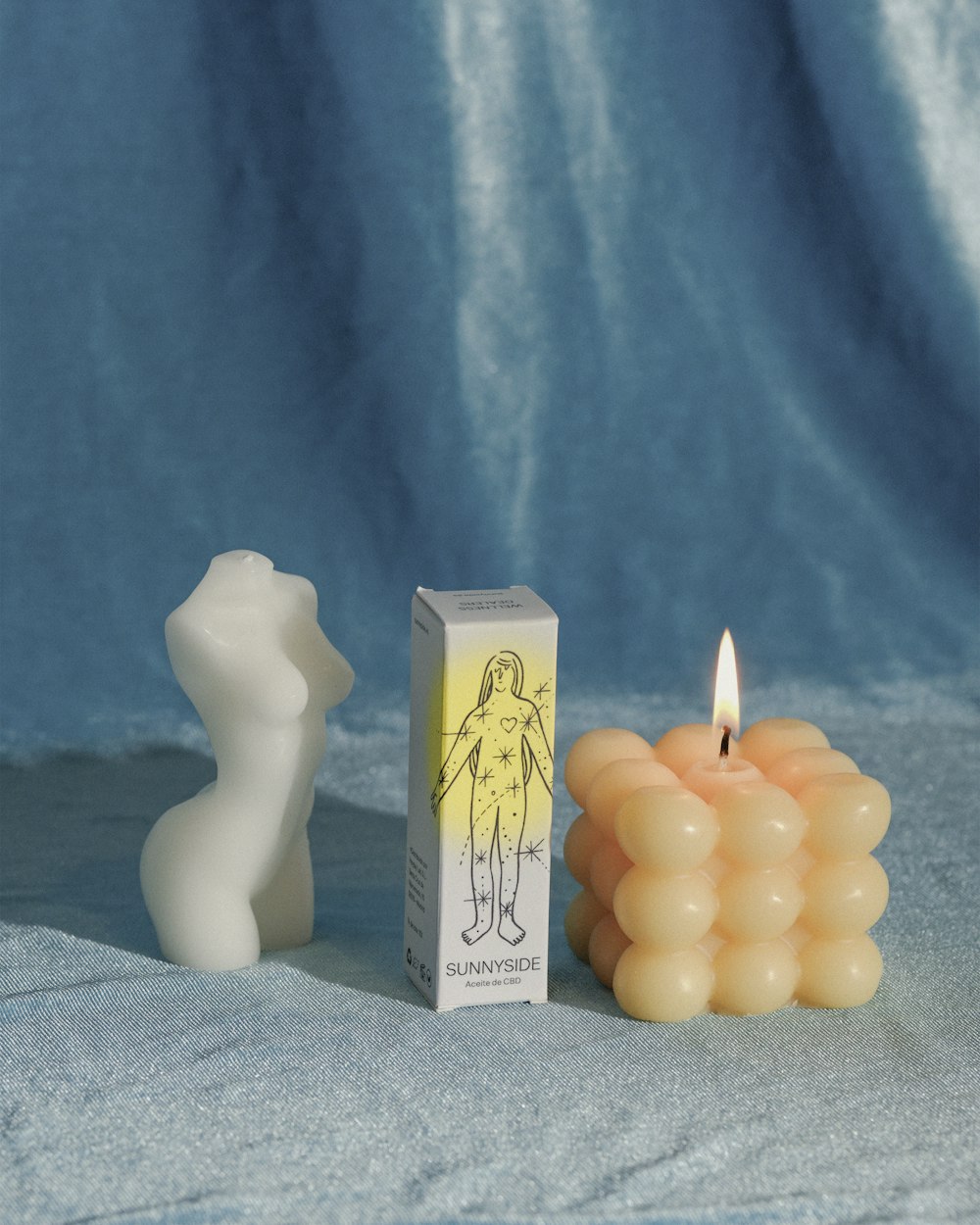 a candle with a box next to it