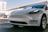 A sleek, modern car parked in an urban setting, showcasing its elegant design and features.