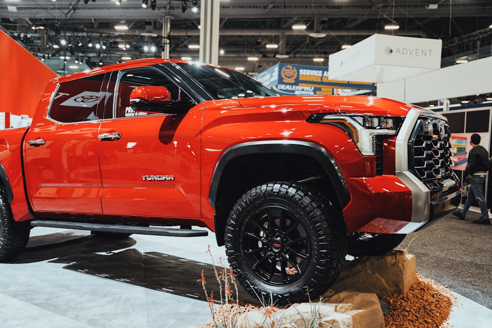 a red truck is on display at a show