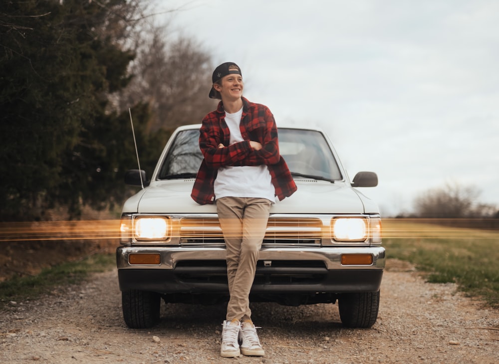 a woman sitting on the hood of a truck