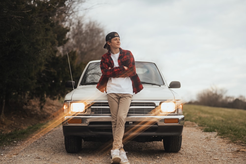 a person sitting on the hood of a car