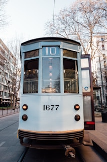 a trolley car is parked on the side of the street