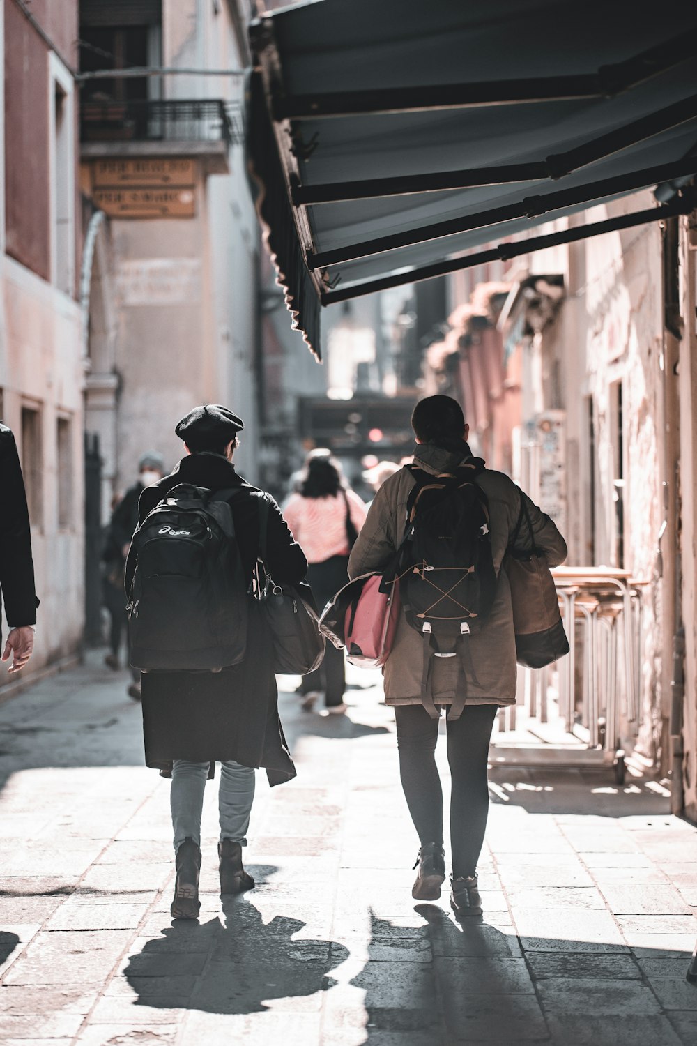 a couple of people that are walking down a street