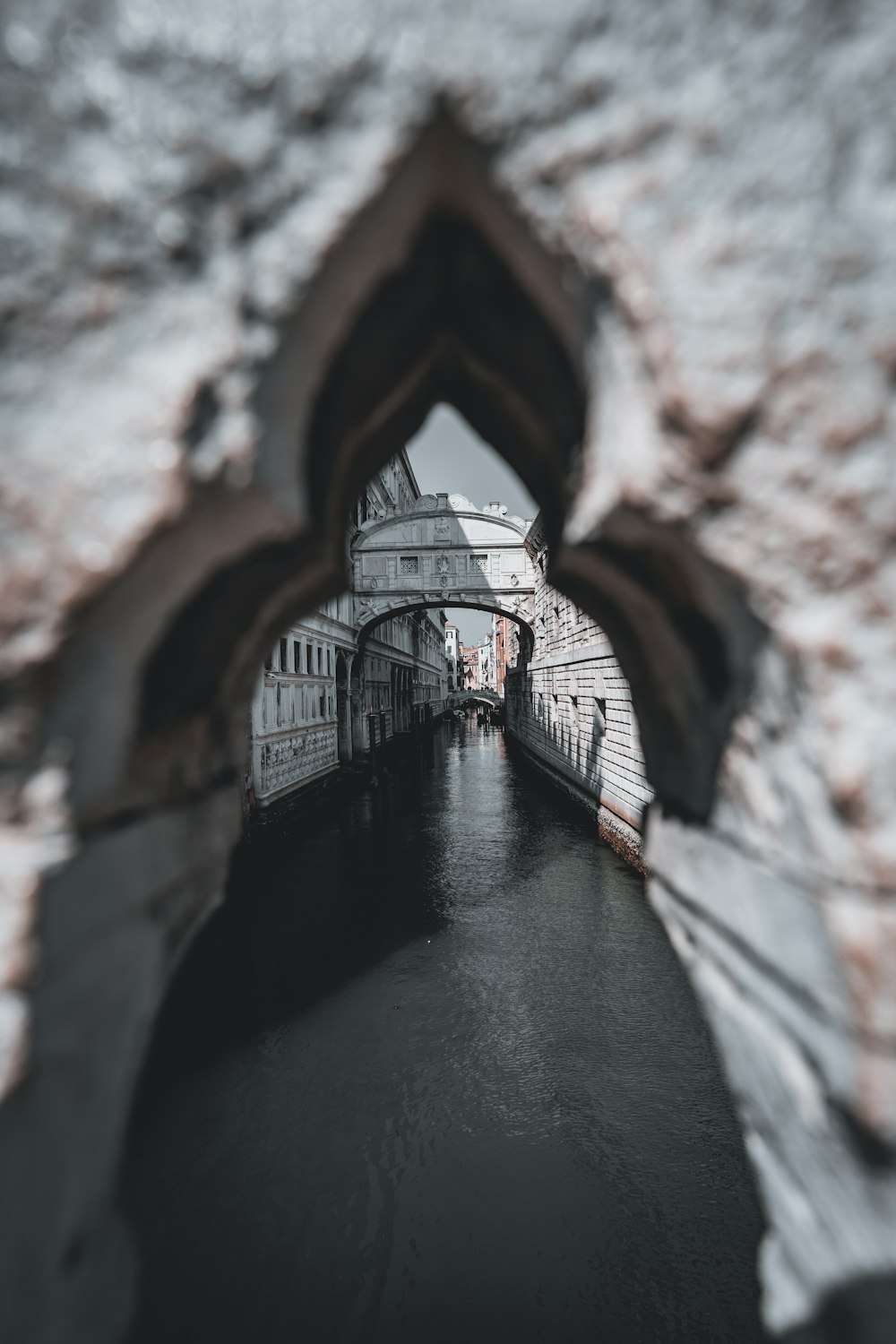 a view of a canal through a hole in the wall